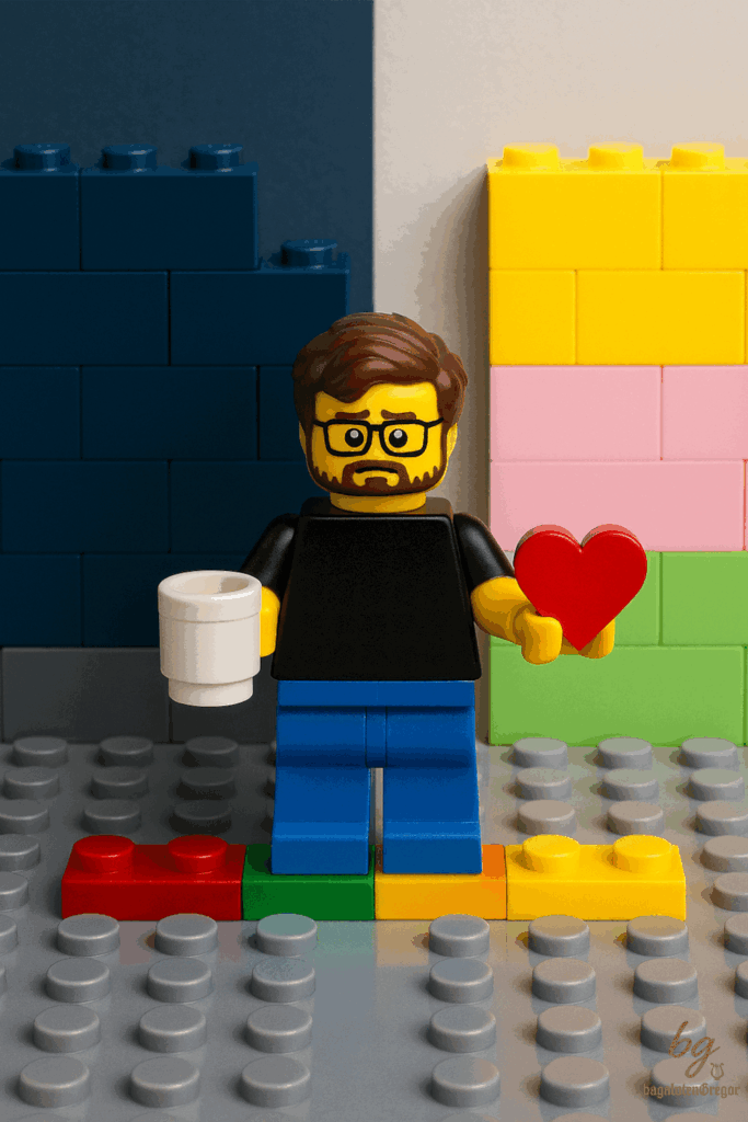 Minifigur balanciert zwischen Alltag und Glück, Kaffeetasse in der einen, Herz in der anderen Hand.